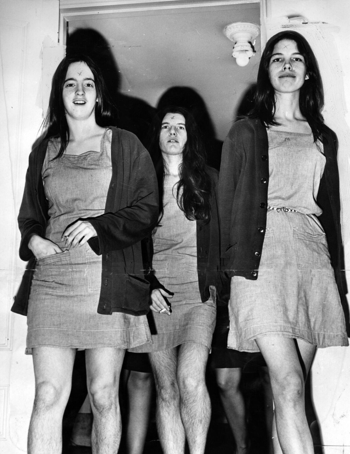 From left, Manson followers Susan Atkins, Patricia Krenwinkel and Leslie Van Houten walk into a morning court session in 1970. When Manson carved an "X" into his forehead during the trial, his "family" members followed suit. ( Los Angeles Times)