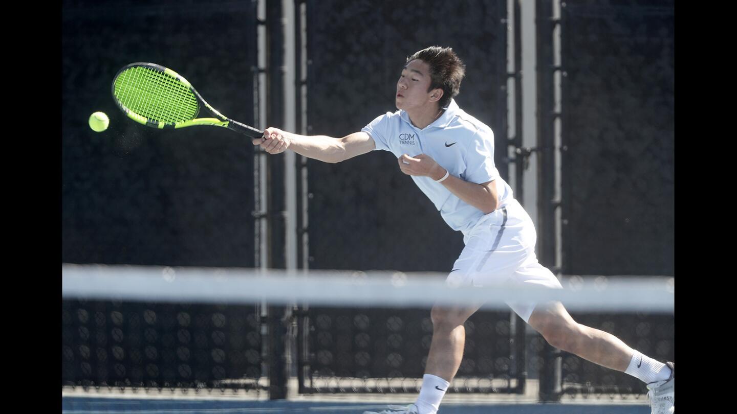 Corona del Mar High No.1 singles player Kyle Pham returns a volley during a set against Palos Verdes in a nonleague match on Wednesday, March 14.