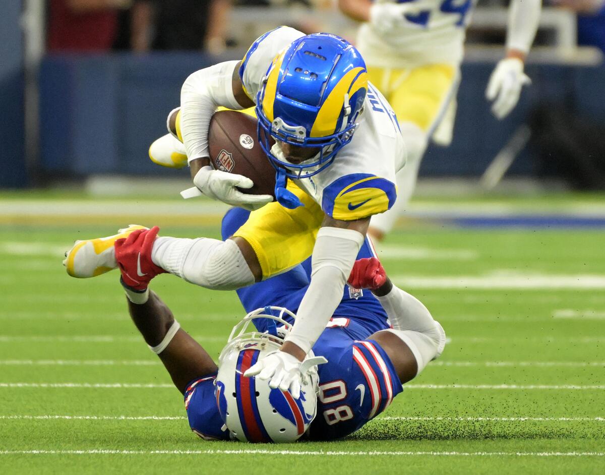 Rams cornerback Troy Hill intercepts the ball in front of Buffalo Bills receiver Jamison Powder.