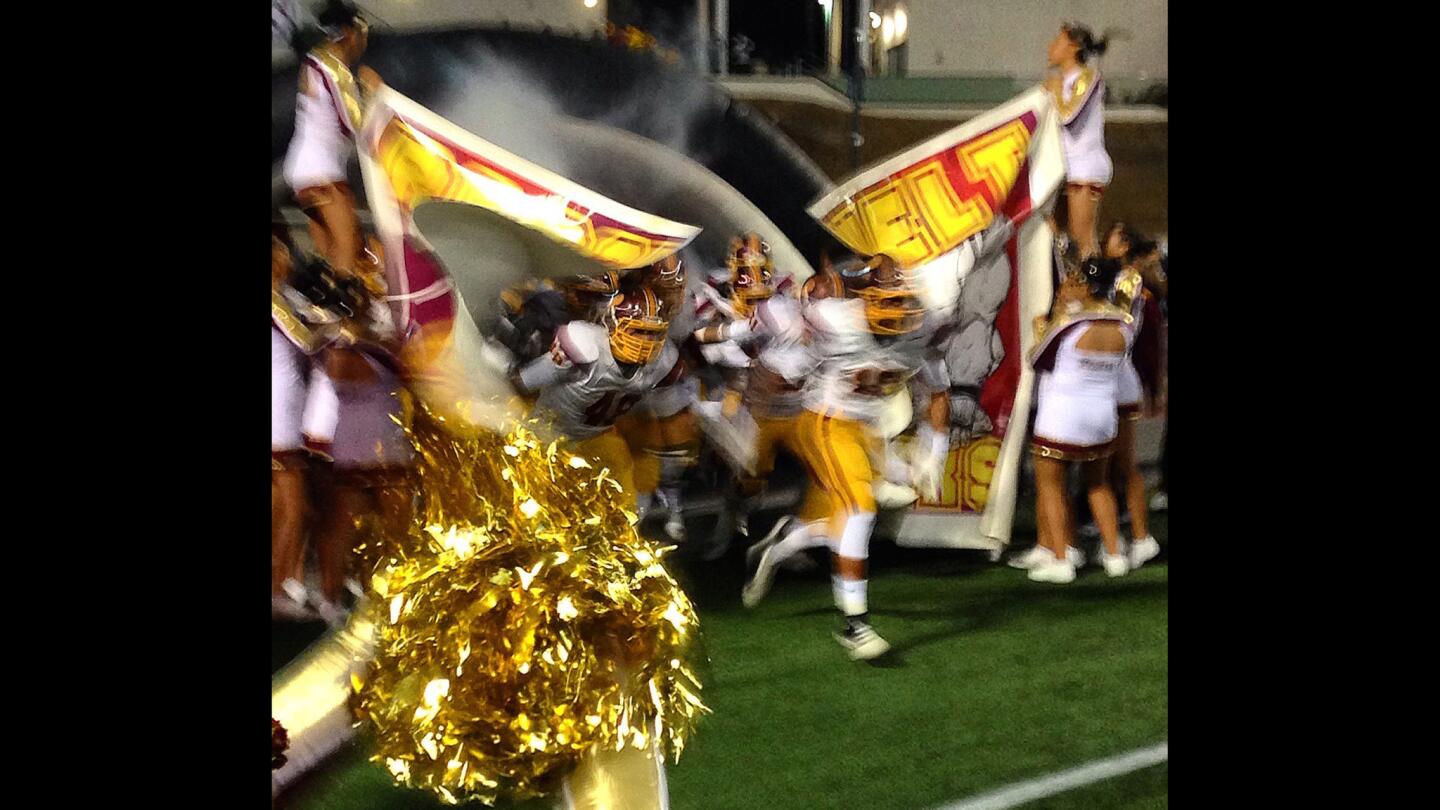 Roosevelt High football players take the field for their annual rivalry game against Garfield at East L.A. College.