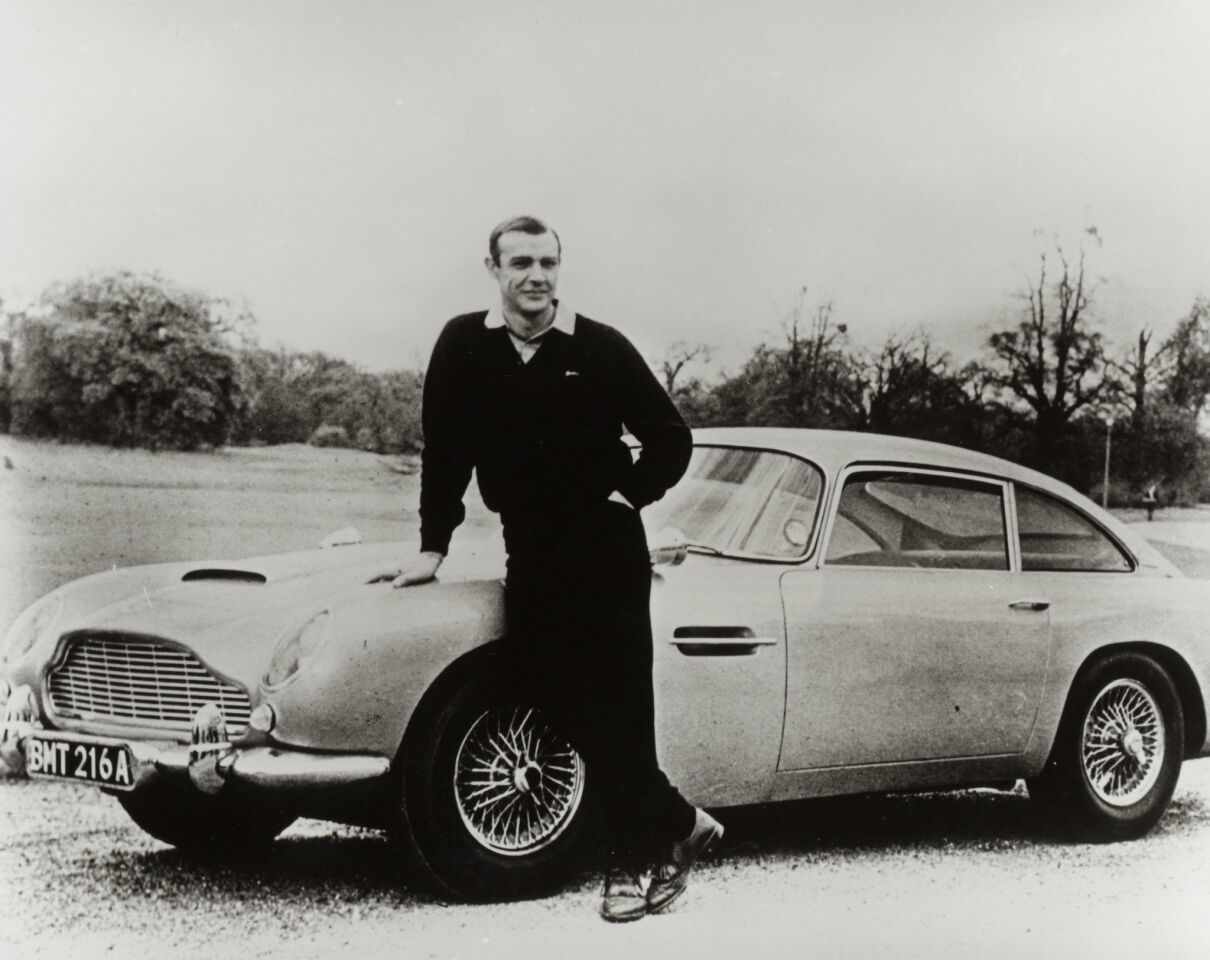 Connery stands with an Aston Martin DB5 for his third 007 film, "Goldfinger."