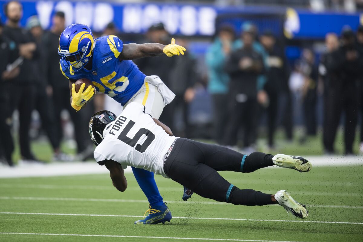Los Angeles Rams running back Sony Michel runs the ball against Jacksonville Jaguars defensive back Rudy Ford.