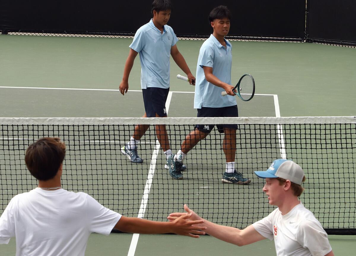Marina's Trevor Nguyen and David Tran walk off the court after losing a set against JSerra on Thursday.