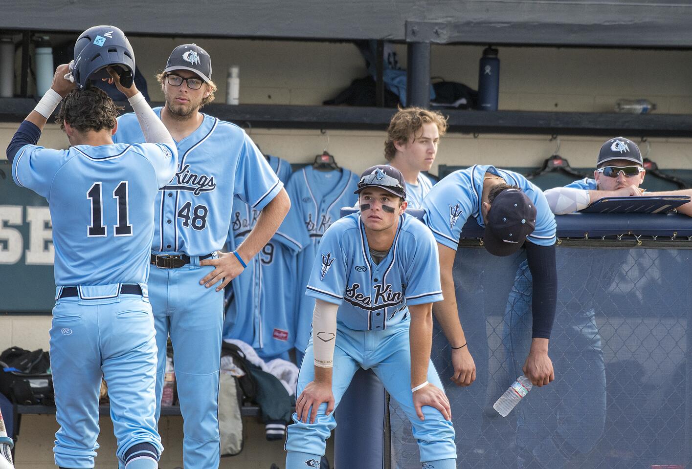 Corona del Mar's bench reacts after Reece Berger (11) hits into a double play in the seventh inning in a Pacific Coast League game against Beckman on Friday, April 6.