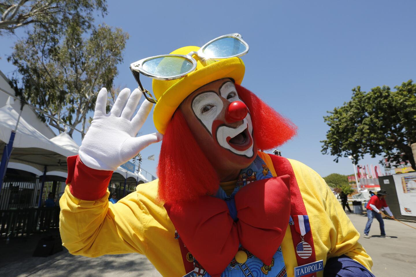 Tadpole the clown is part of the greeting committee on opening day of the O.C. Fair in Costa Mesa.