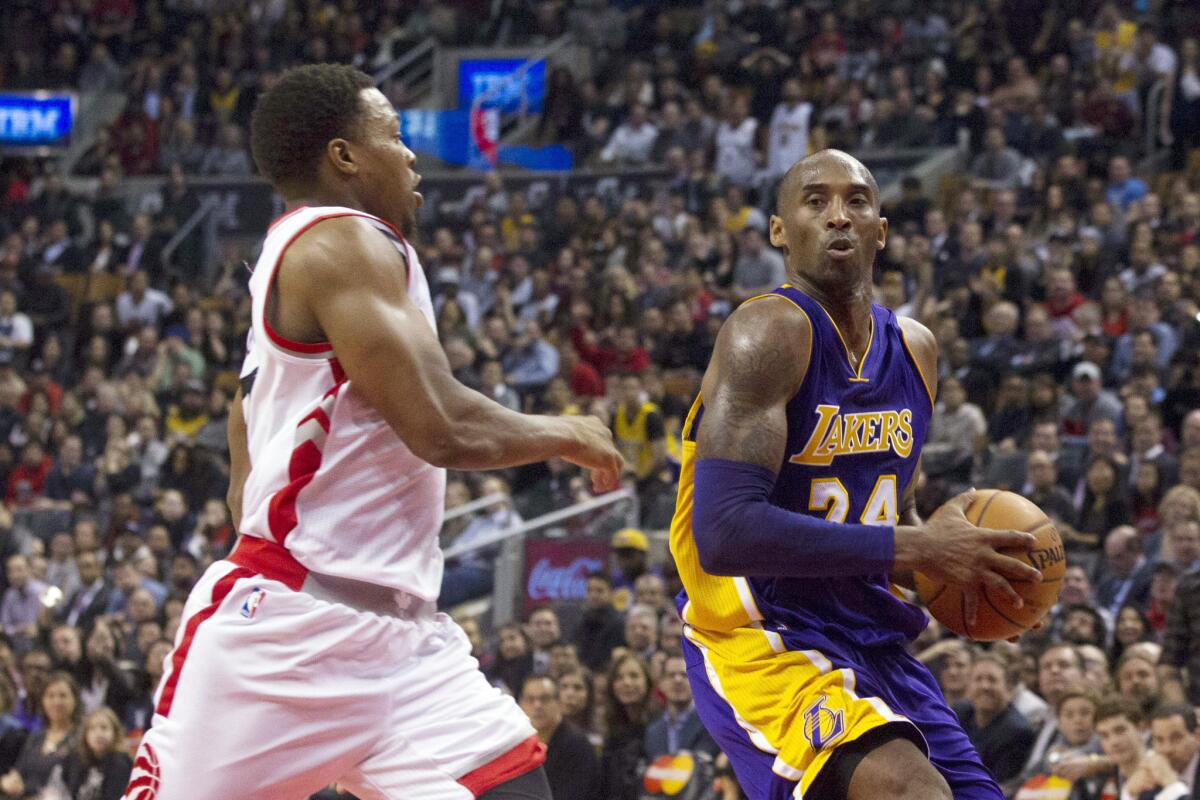 Lakers forward Kobe Bryant drives past Raptors guard Kyle Lowry during the second half.