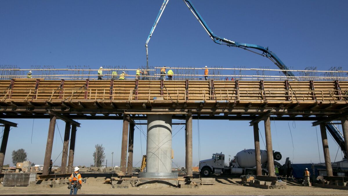 Workers in 2017 pour concrete onto one of the elevated sections of the high-speed rail section that will cross over the San Joaquin River near Fresno.