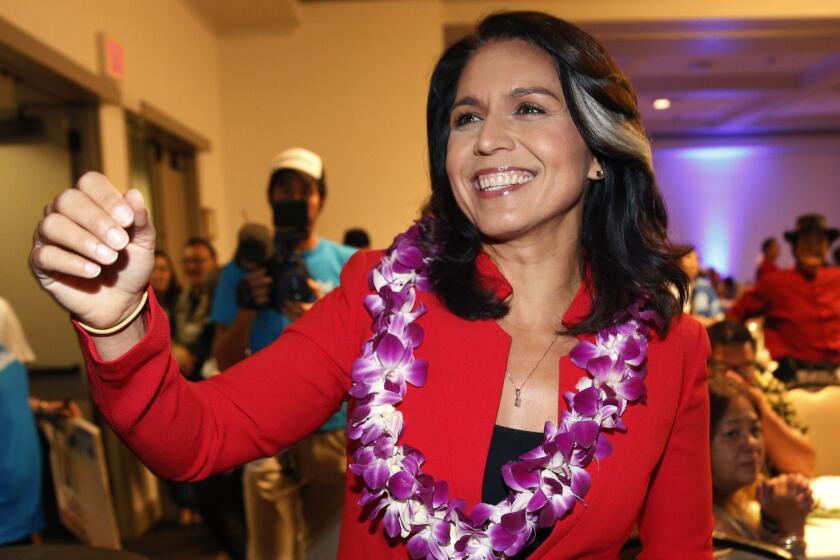 FILE - In this Nov. 6, 2018, file photo, Rep. Tulsi Gabbard, D-Hawaii, greets supporters in Honolulu. Gabbard has announced sheâs running for president in 2020. The 37-year-old Gabbard said in a CNN interview slated to air Saturday night that she will be formally announcing her candidacy within the week. (AP Photo/Marco Garcia, File)