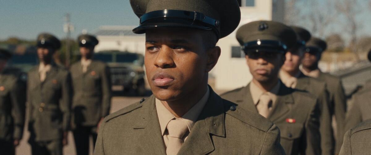 A young man in military uniform stands in formation.