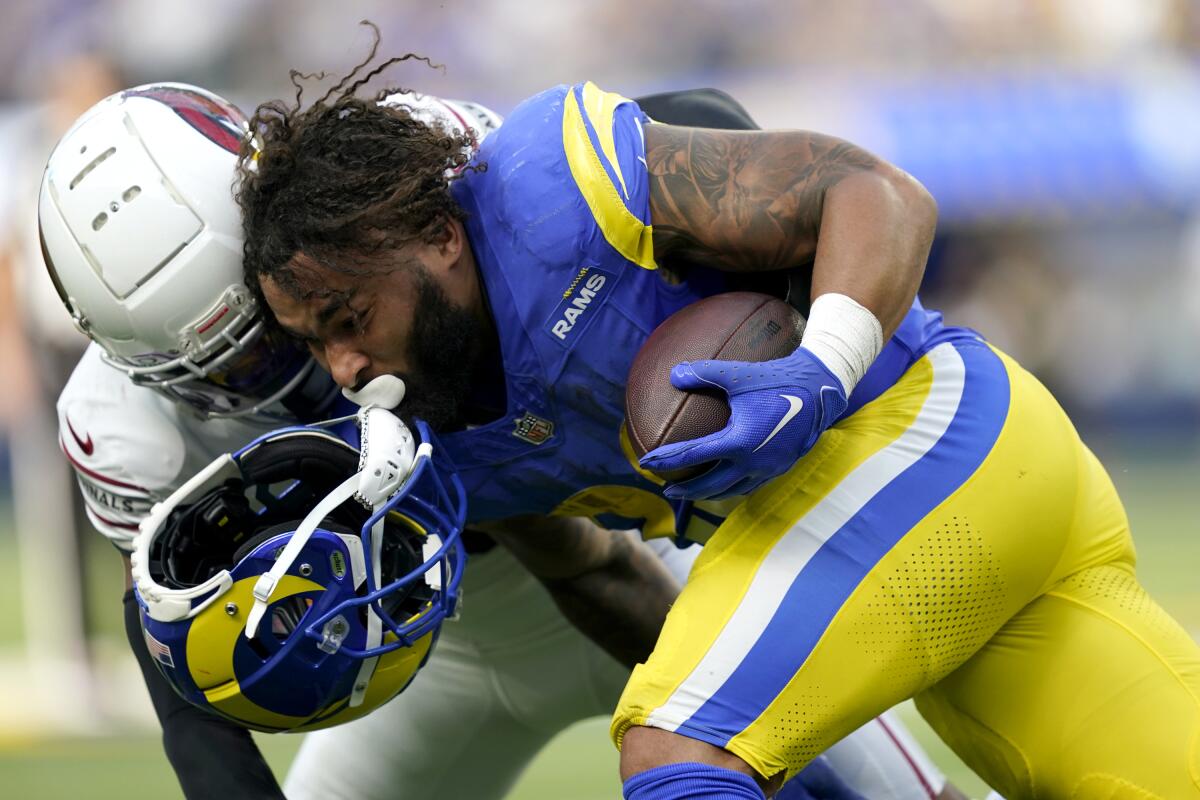 Rams running back Kyren Williams is tackled by Arizona Cardinals cornerback Marco Wilson during the third quarter.