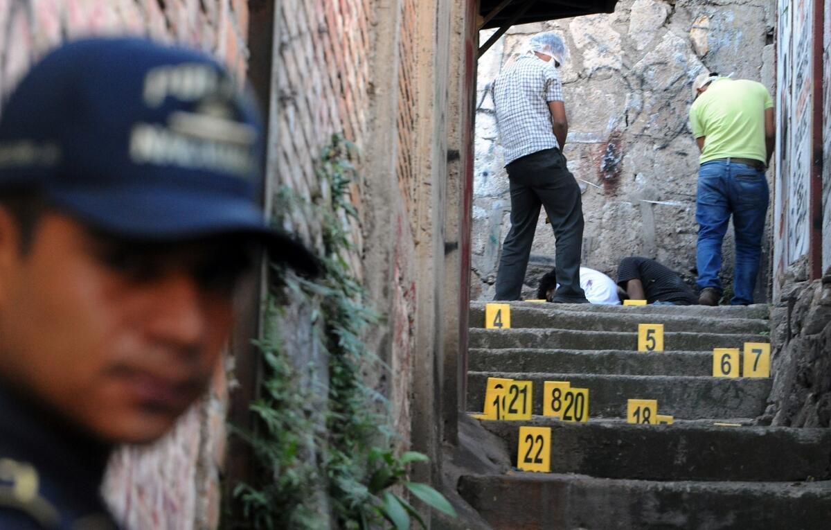 Honduran police stand guard at the scene where four youngsters were shot and killed in Tegucigalpa.