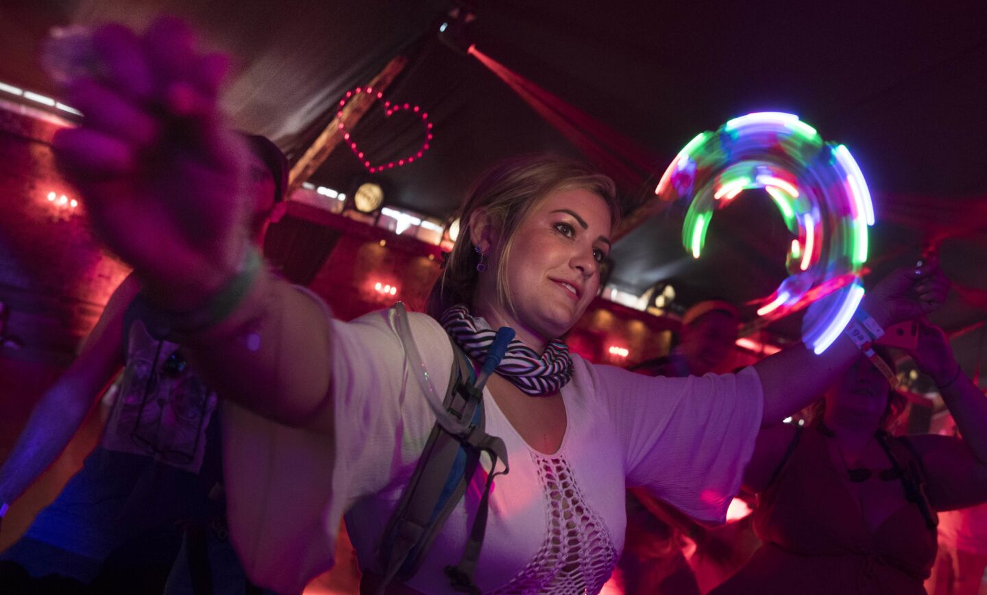 INDIO, CALIF. -- FRIDAY, APRIL 14, 2017: Lauren C, 28, of Temecula spins a LED light inside the Yuma tent at the Coachella Music and Arts Festival in Indio, Calif., on April 14, 2017. (Brian van der Brug / Los Angeles Times)
