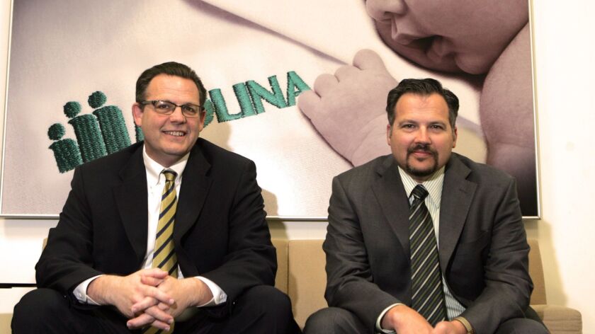 J. Mario Molina, left, former chairman and CEO of Molina Healthcare, and his brother John Molina, seen in their Long Beach corporate office in 2010. Their father founded the company.