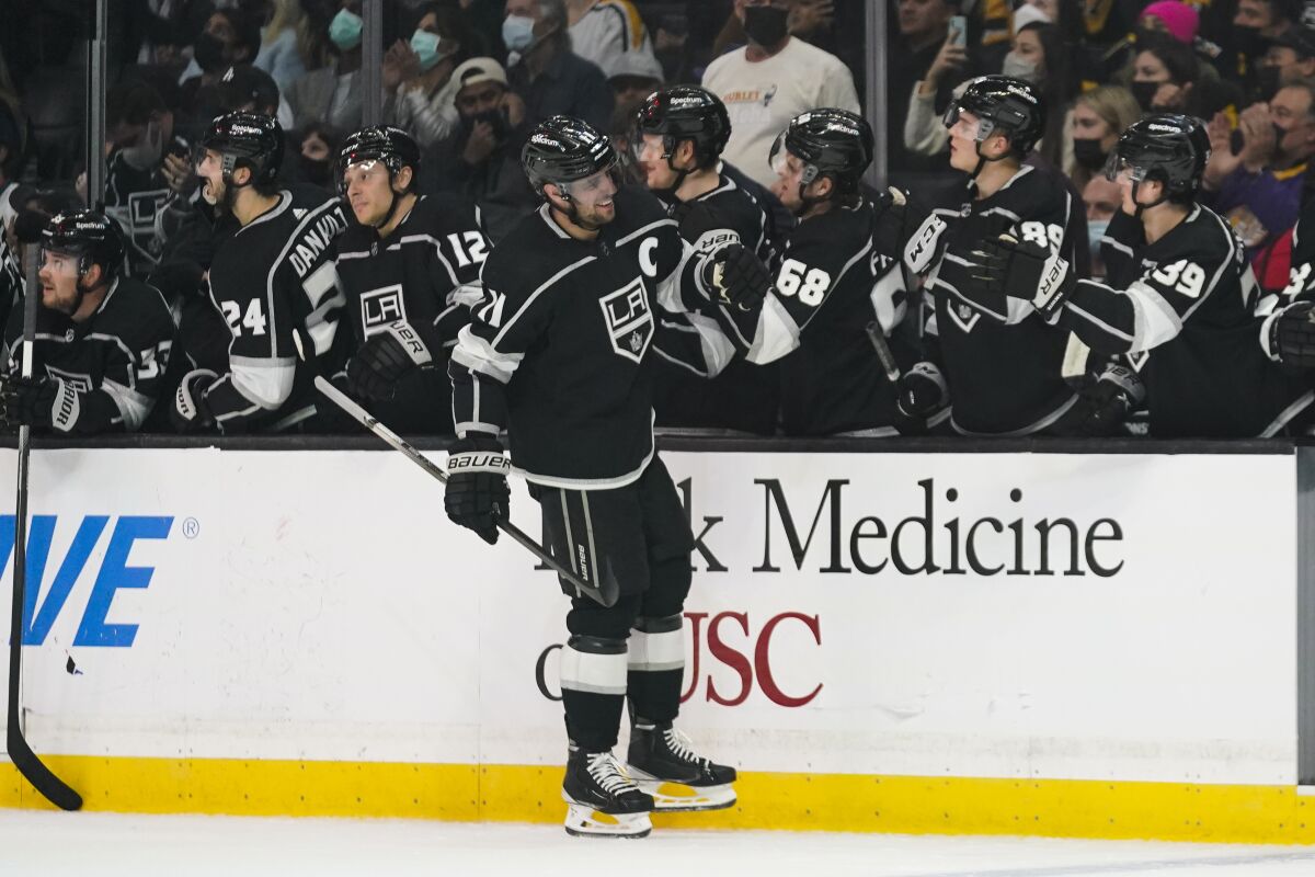 Los Angeles Kings' Anze Kopitar, center, celebrates his goal against the Pittsburgh Penguins during the first period of an NHL hockey game Thursday, Jan. 13, 2022, in Los Angeles. (AP Photo/Jae C. Hong)
