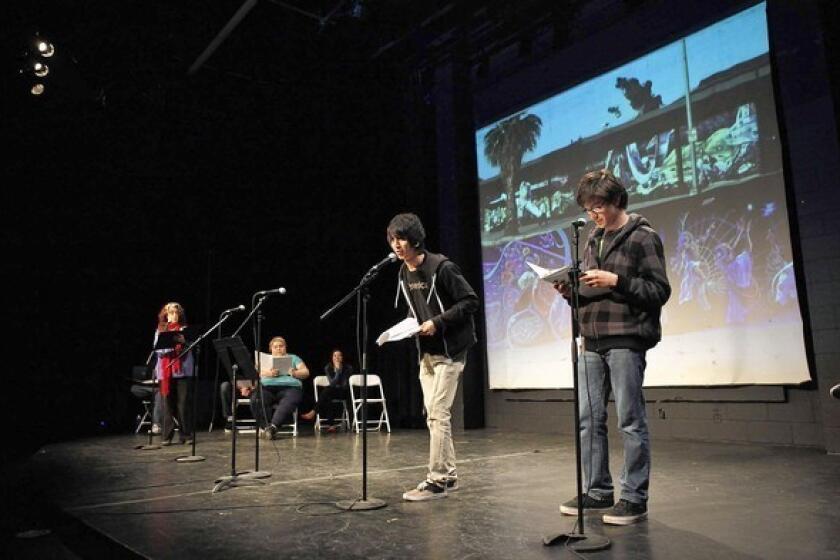 Monterey Continuation High School students Christopher Lizarraras, center, and Jose Herrera, right, participate in a play about the East Los Streetscapers -- muralists Wayne Healy and David Botello -- during a performance at the Plaza de la Raza's Margo Albert Theater.