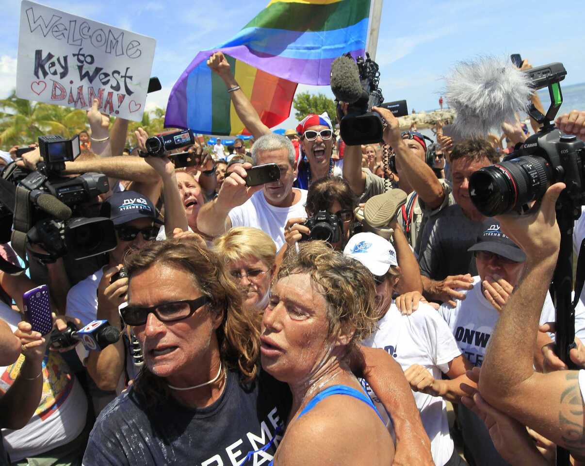 U.S. long-distance swimmer Diana Nyad (front right), 64, is welcomed ashore after completing her swim from Cuba as she arrives in Key West, Florida, September 2, 2013.