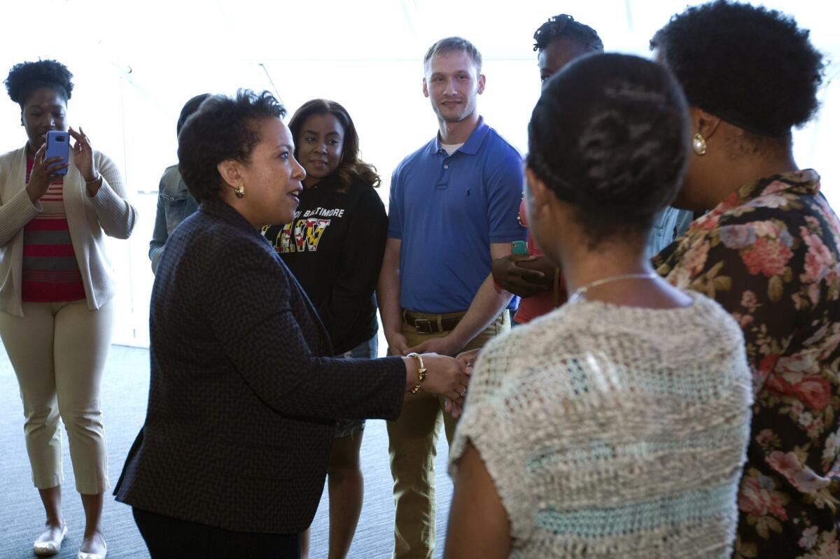 Atty. Gen. Loretta Lynch shakes hands with students before meeting with members of Congress and faith leaders at the University of Baltimore on Tuesday, May 5, 2015, in Baltimore.