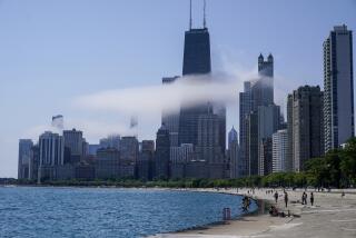 The Chicago city skyline is covered by the fog lifted off Lake Michigan on Aug. 5, 2022, in Chicago. Democrats have chosen Chicago to host their 2024 national convention. (AP Photo/Kiichiro Sato, File)