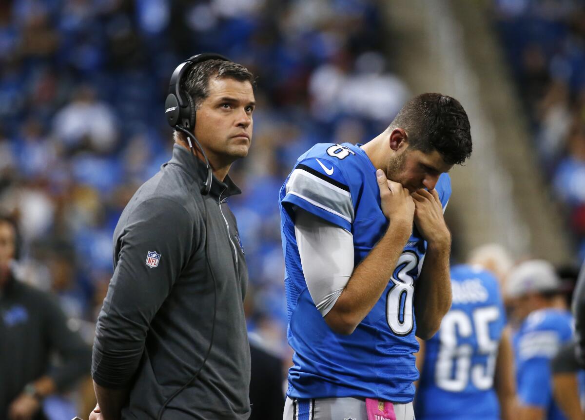 Detroit Lions offensive coordinator Joe Lombardi looks on with quarterback Dan Orlovsky 