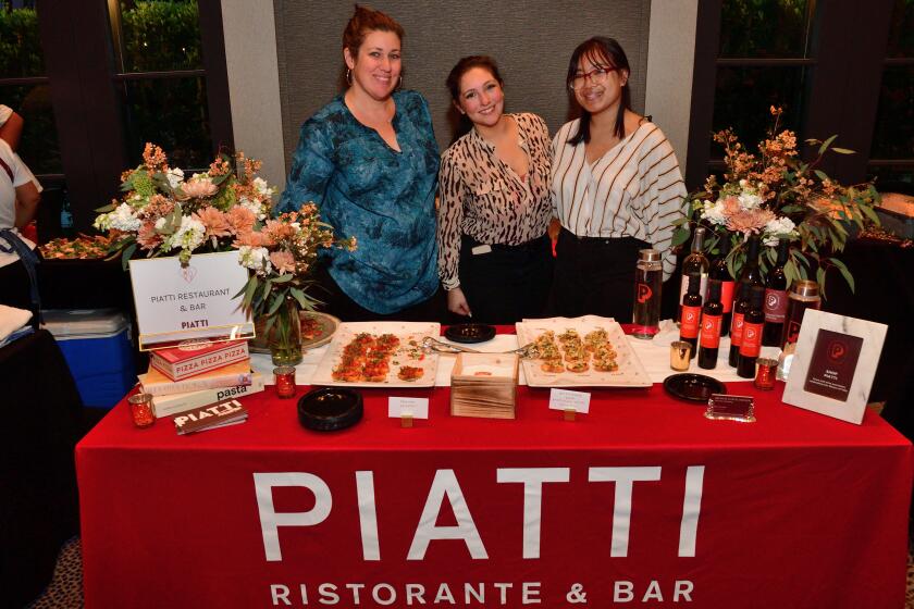 Kasey Crancer, Jen Parsons and Mieko Robert greet visitors to the Piatti Ristorante & Bar table.
