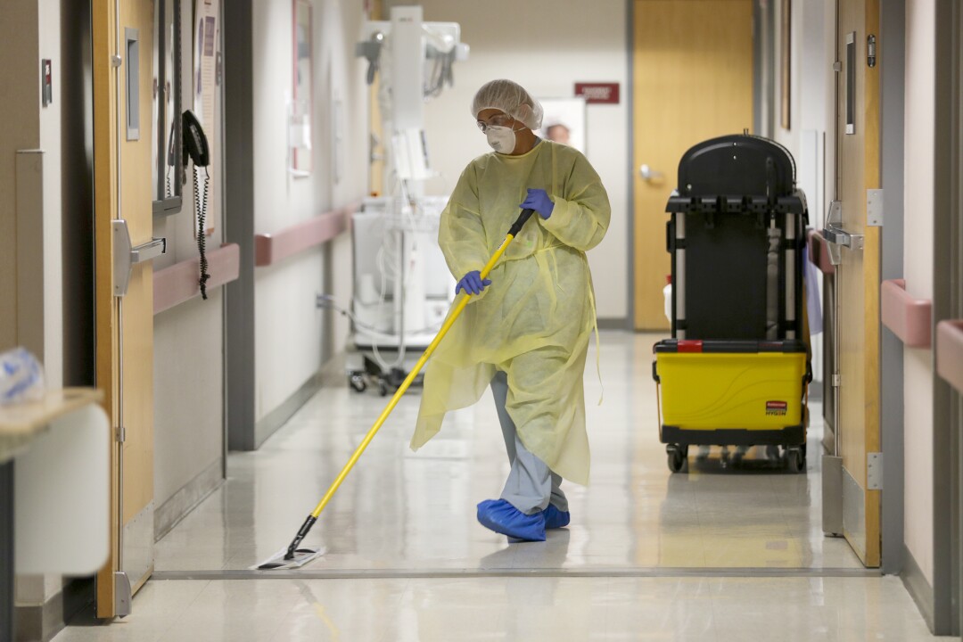 A patient's return to hospital COVID-19 unit underscores
uncertainty to come 5 Maria Quintero makes sure that COVID-19 unit is clean at Desert Valley Medical Group, Victorville.