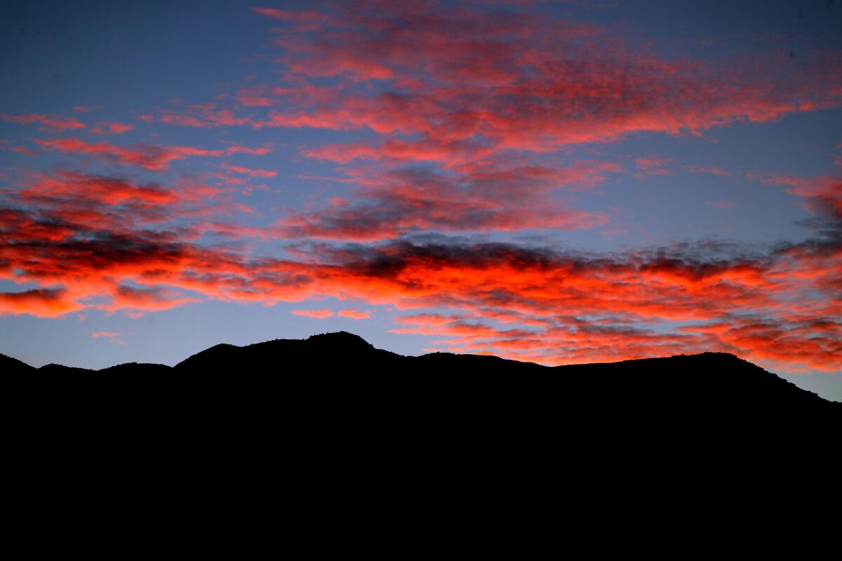 Sunrise reflected in pink clouds over the San Gabriel Mountains
