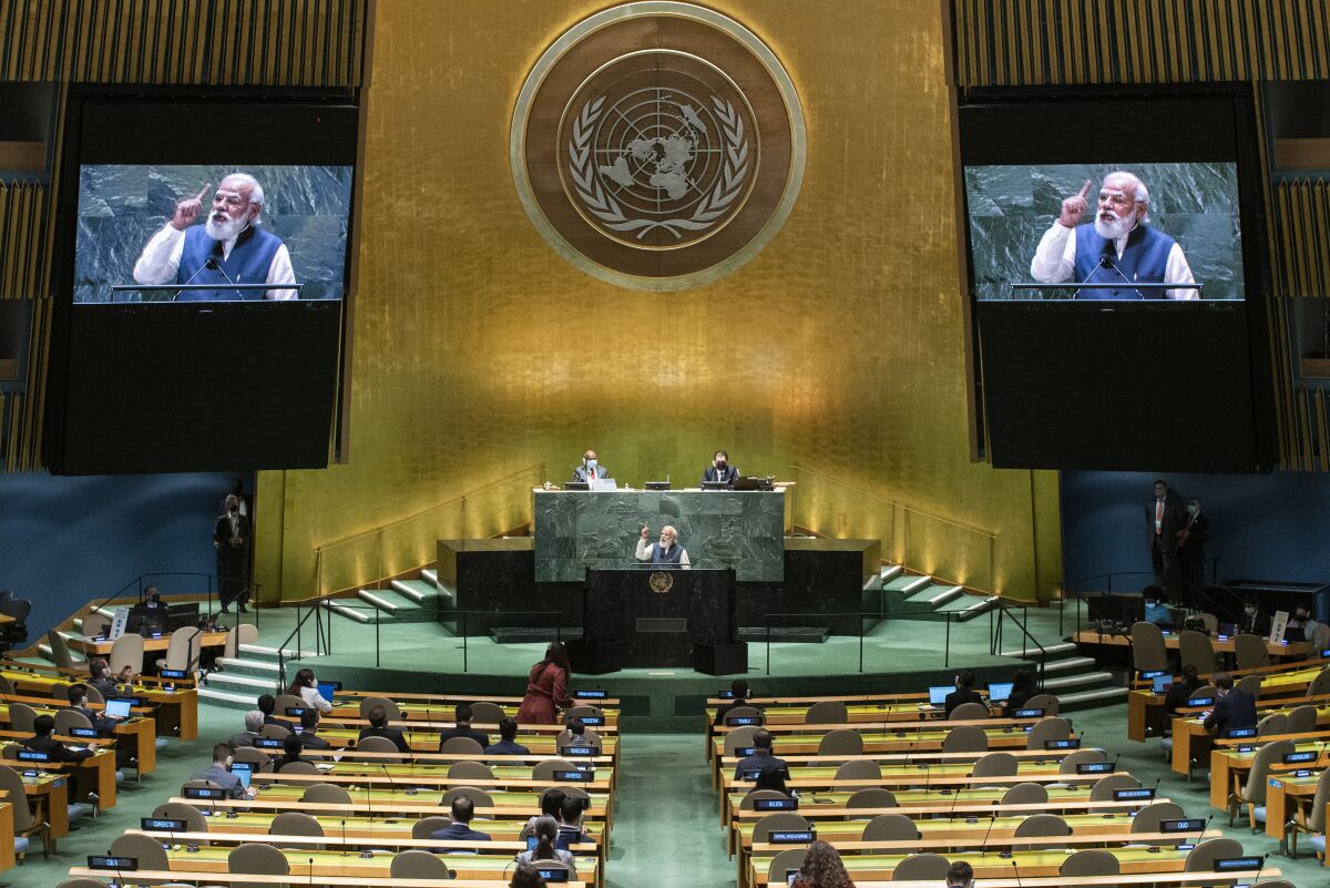 India's Prime Minister Narendra Modi addresses the U.N. General Assembly from a podium with large video screens above him