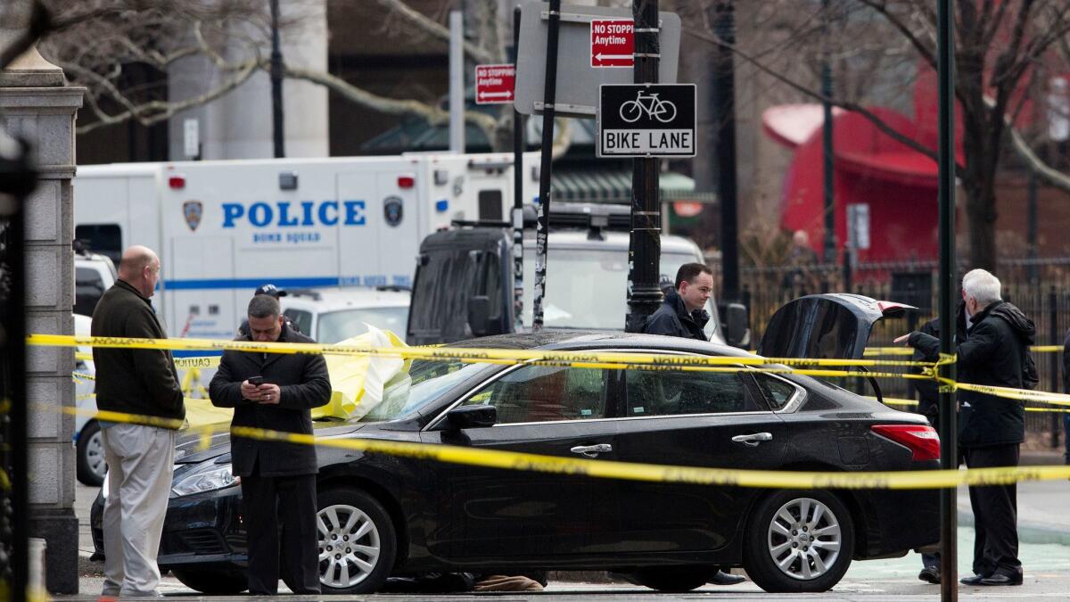 Police examine the car in which 61-year-old Douglas Schifter committed suicide Feb. 5.