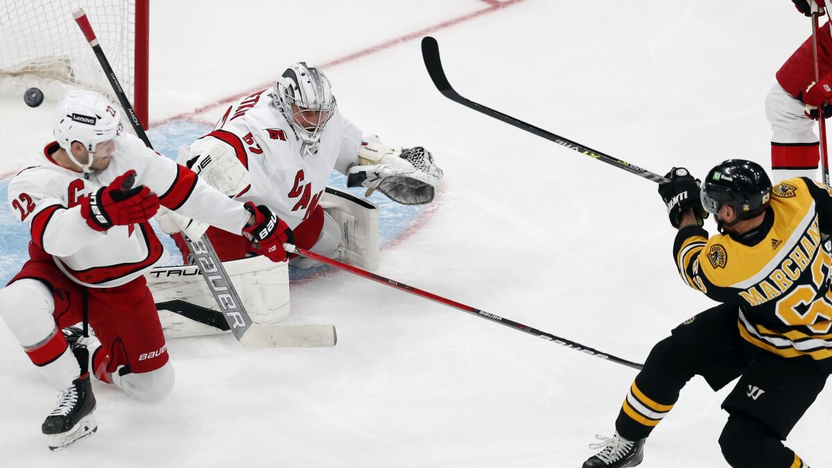 Boston Bruins' Brad Marchand (63) scores against Carolina Hurricanes' Pyotr Kochetkov (52) during the second period of Game 3 of an NHL hockey Stanley Cup first-round playoff series, Friday, May 6, 2022, in Boston. (AP Photo/Michael Dwyer)