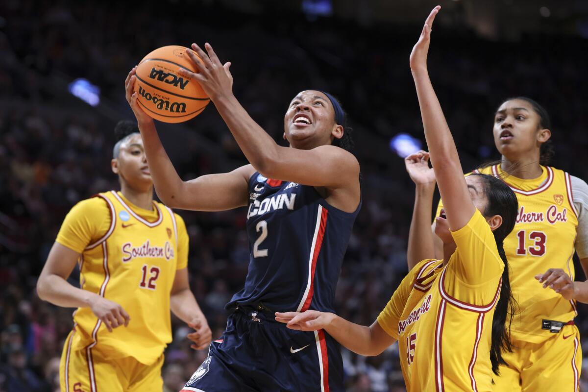 Connecticut guard KK Arnold puts up a shot against USC during the first half Monday.