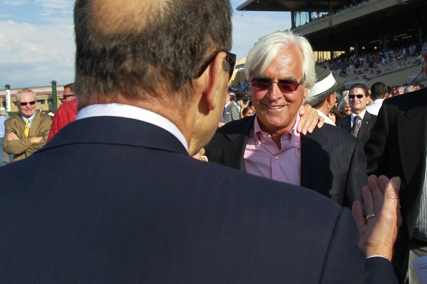 Game On Dude owner Joe Torre and trainer Bob Baffert celebrates afte their horse won the Pacific Classic at the Del Mar Thoroughbred Club.