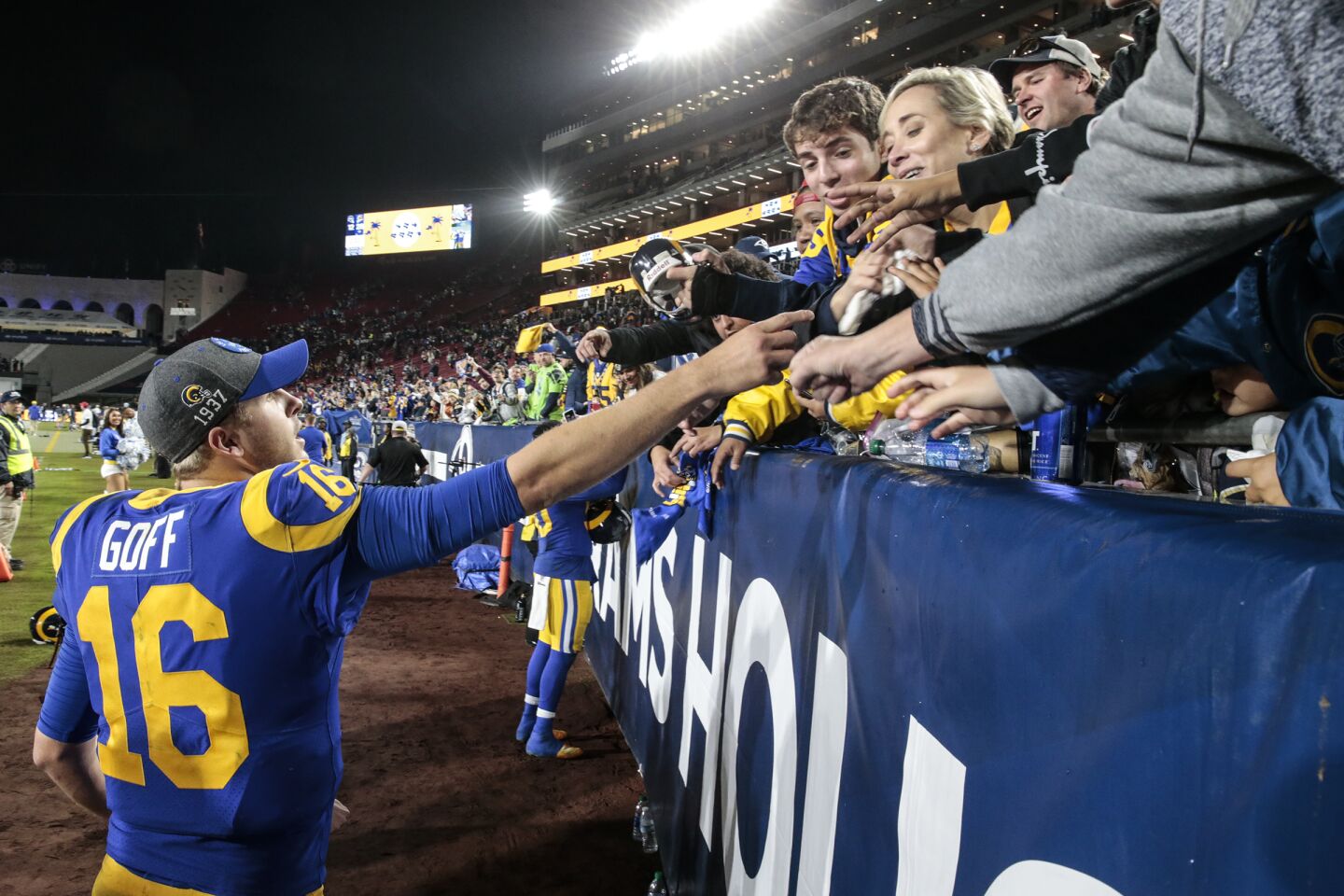 Rams quarterback Jared Goff gives a sweatband to a fan after leading his team to a 28-12 win over the Seattle Seahawks.