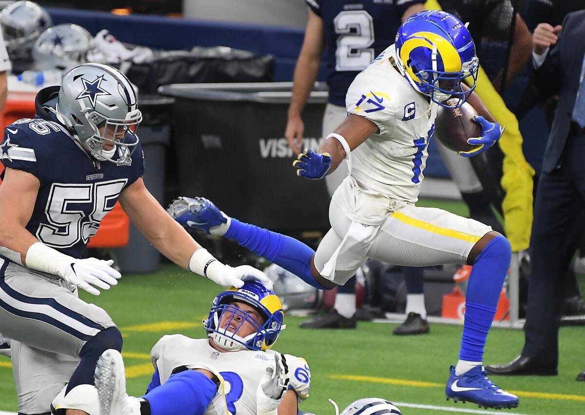 Rams receiver Robert Woods leaps over Cowboys safety Darian Thompson.