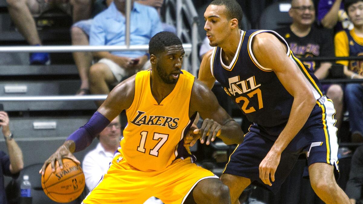 Lakers center Roy Hibbert (17) works in the post against Jazz center Rudy Gobert (27) in the second half of their exhibition game Sunday in Hawaii.