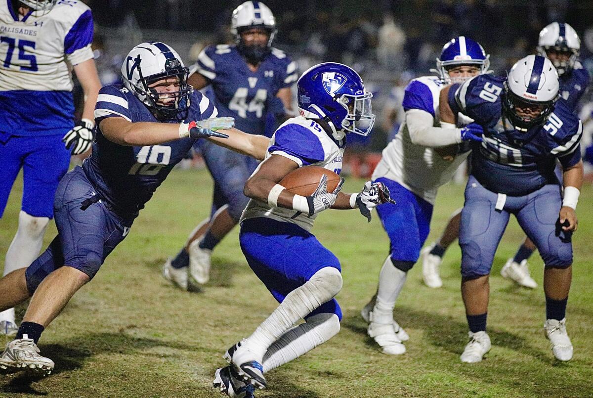 Palisades tailback Teralle Watson gains a first down in the fourth quarter of a 28-24 Western League victory at Venice.