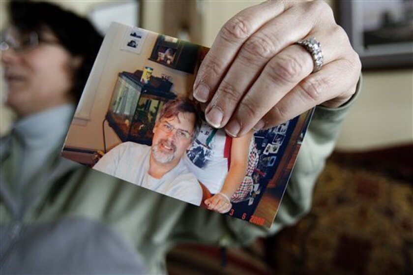 Andrea Phillips holds a photo of her husband, Capt. Richard Phillips on Wednesday, April 8, 2009, at her home in Underhill, Vt. Phillips is the captain of the U.S.-flagged cargo ship Maersk Alabama which was hijacked by Somali pirates off the Horn of Africa. (AP Photo/Toby Talbot)