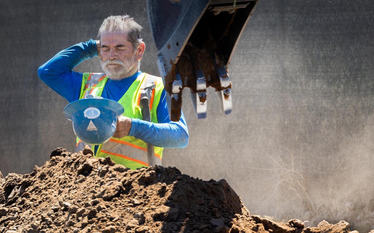 A construction worker takes a break amid a heat wave in Irvine on Sept. 5. 