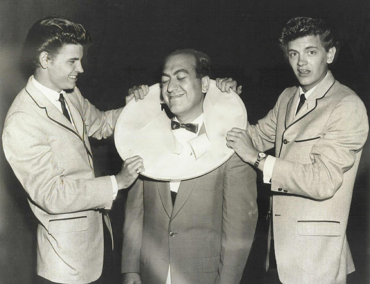 In this 1950s archival photo, Art Laboe, center, pals around with Don, left, and Phil of the Everly Brothers.