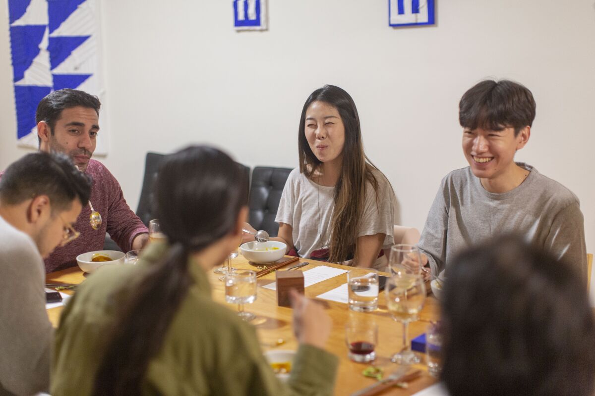 Guests enjoy artist Michelle Lee's art pop-up dinner, Sung