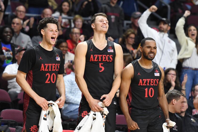 LAS VEGAS, NEVADA - NOVEMBER 28: Jordan Schakel #20, Yanni Wetzell #5 and KJ Feagin #10 of the San Diego State Aztecs celebrate after teammate Joel Mensah (not pictured) #35 dunked against the Creighton Bluejays during the 2019 Continental Tire Las Vegas Invitational basketball tournament at the Orleans Arena on November 28, 2019 in Las Vegas, Nevada. The Aztecs defeated the Bluejays 83-52. (Photo by Ethan Miller/Getty Images)