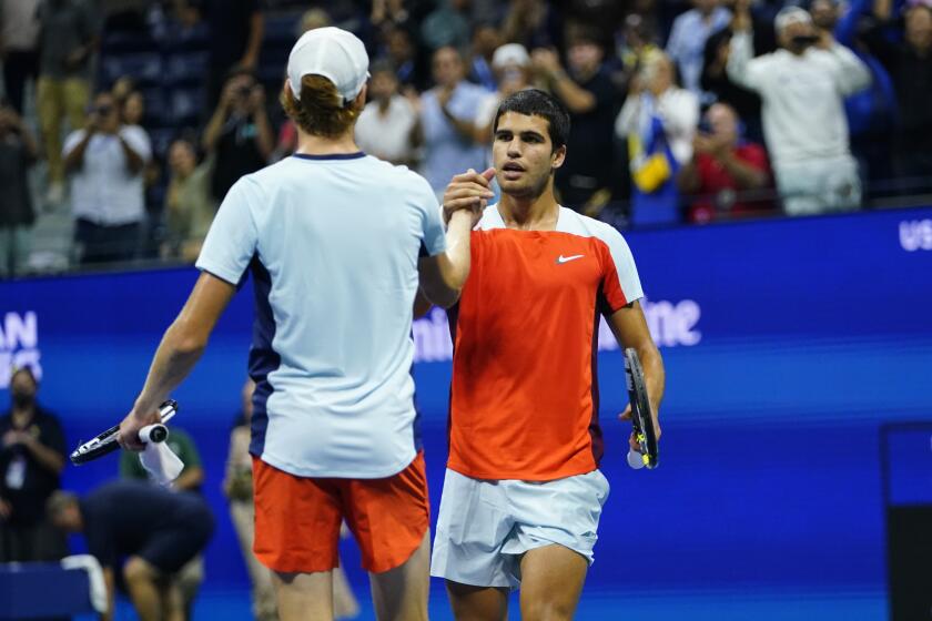 Carlos Alcaraz, of Spain, right, shakes hands with Jannik Sinner, of Italy, after Alcaraz won their match in the quarterfinals of the U.S. Open tennis championships, early Thursday, Sept. 8, 2022, in New York. (AP Photo/Frank Franklin II)