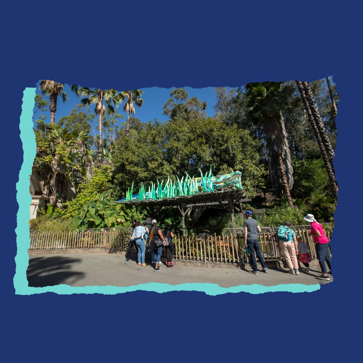 People look into an enclosure at the L.A. Zoo.