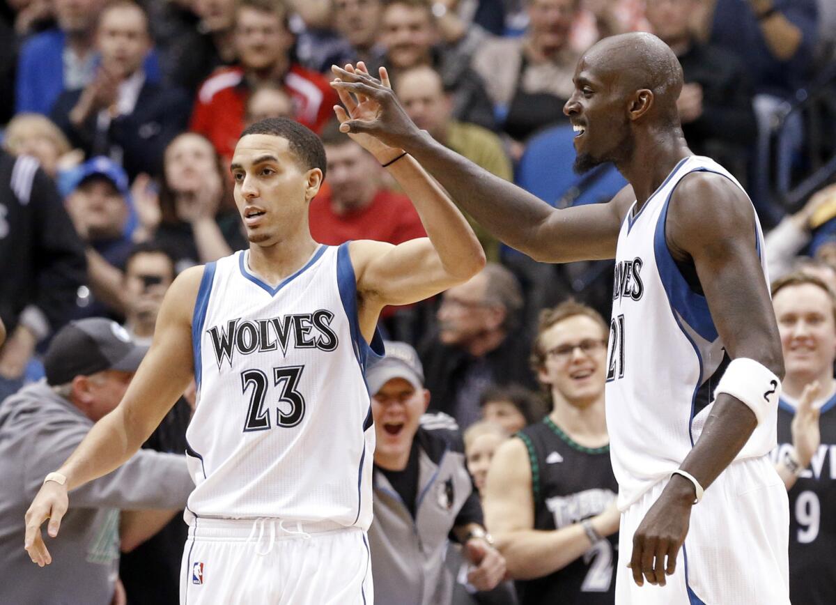 Minnesota guard Kevin Martin and forward Kevin Garnett, left, celebrate after a basket in the second half of the Timberwolves' 97-77 win Wednesday over the Washington Wizards.