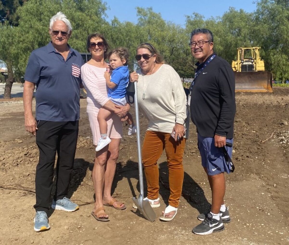 Donors John and Janine Colich, coach Anna Collier and AD Harvey Kitani at beach volleyball courts at Rolling Hills Prep.