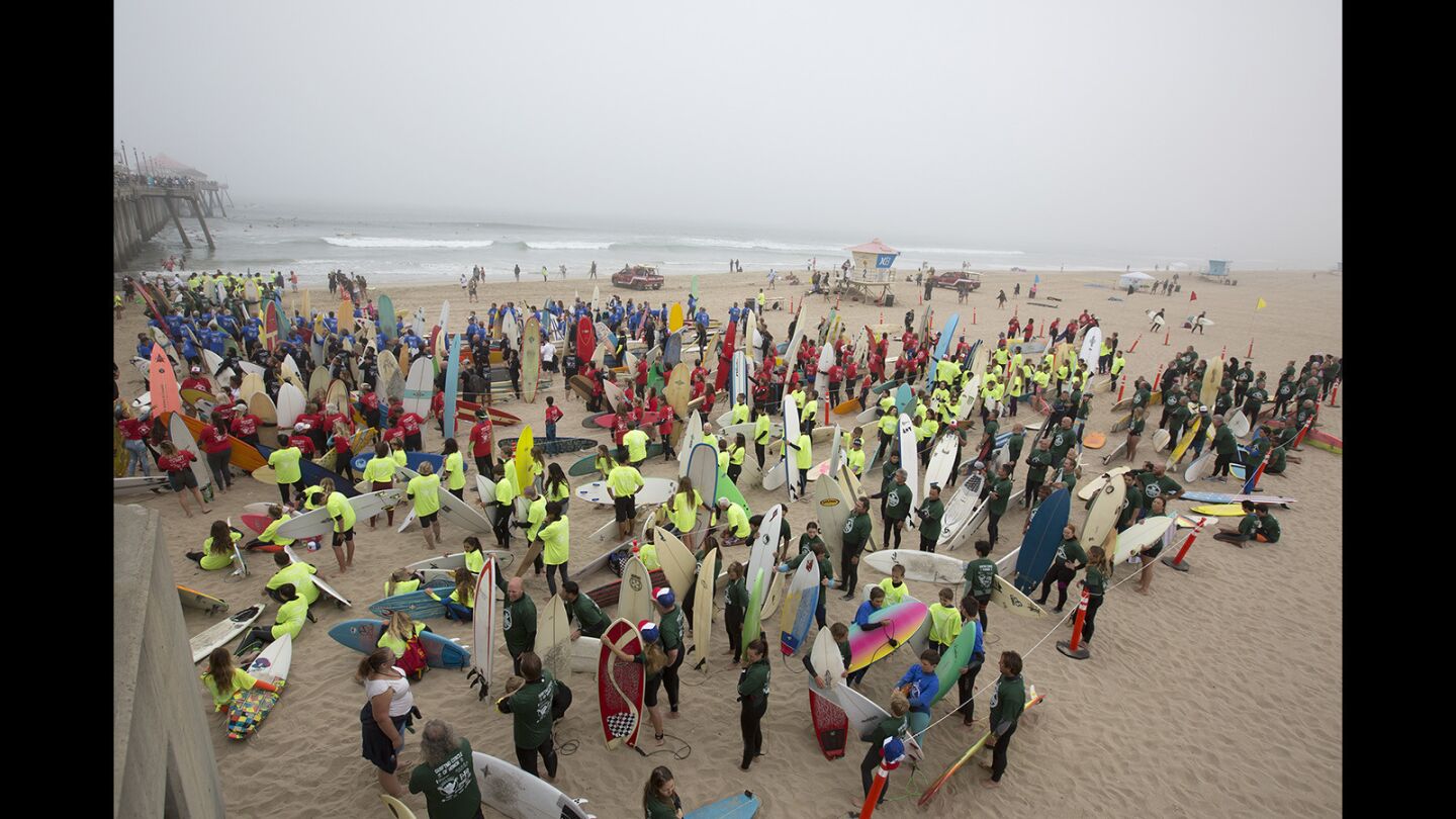 Photo Gallery: 500 surfers paddle out for a record-setting attempt to promote Huntington Beach for the 2024 Olympics