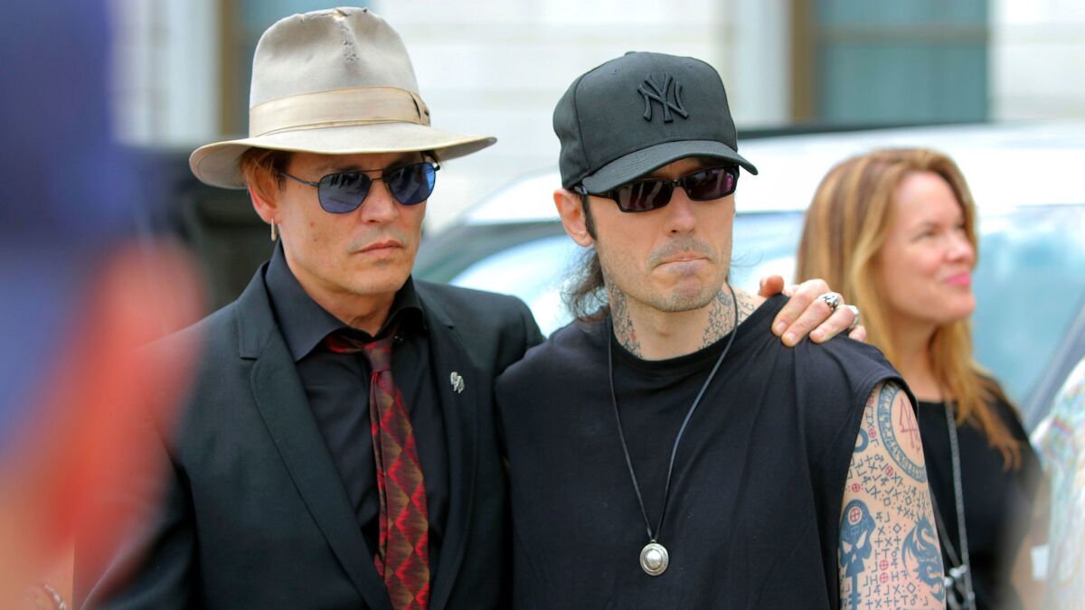 Actor Johnny Depp, left, joins former Arkansas death row inmate Damien Echols at a rally against executions that had been scheduled this month in Arkansas.