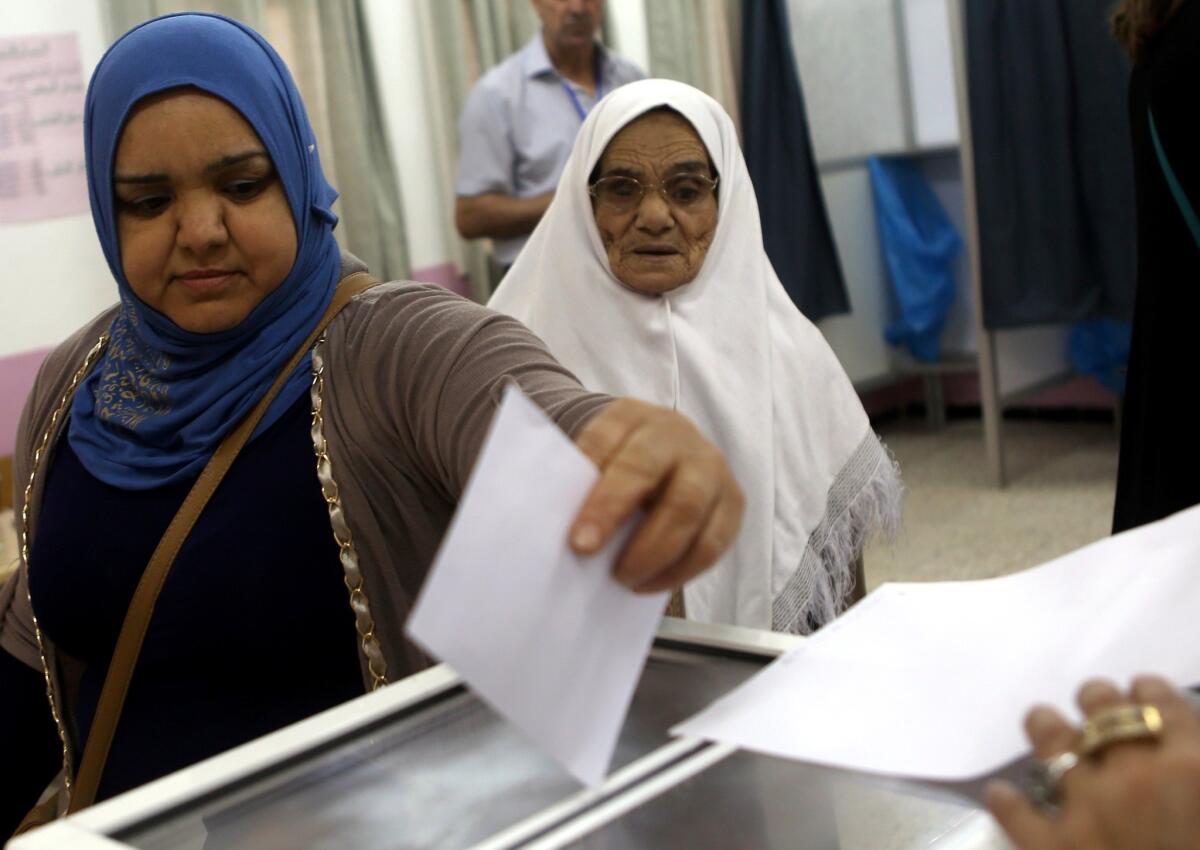 An Algerian woman casts her ballot at a polling station in Algiers.