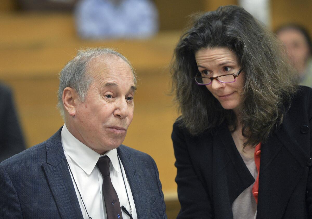Paul Simon and wife Edie Brickell appear at a hearing in Norwalk, Conn., last week after they were arrested and charged with disorderly conduct. Simon played his first public concert since the incident on Wednesday in New York.
