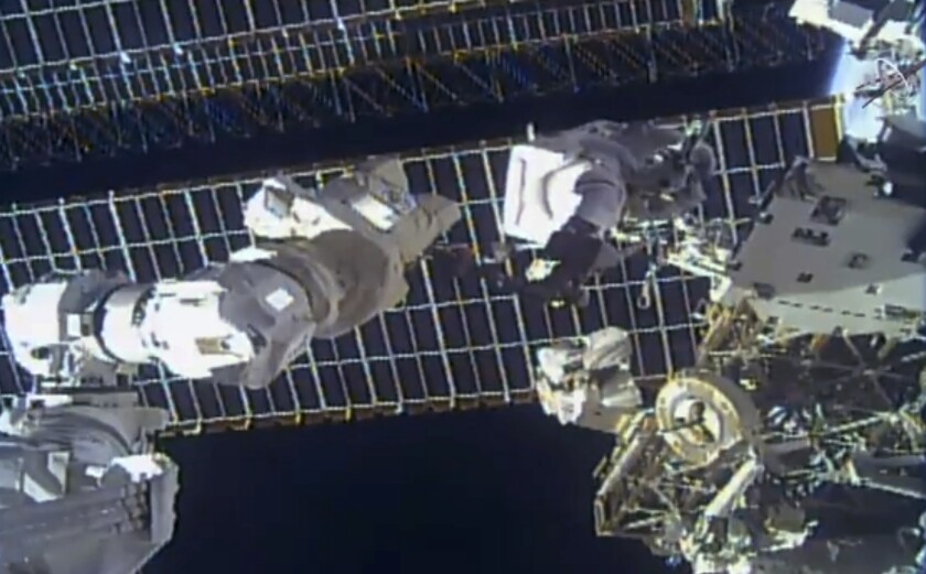 This photo provided by NASA shows astronaut Tom Marshburn replaces a broken antenna outside the International Space Station after getting NASA's all-clear for orbiting debris, on Thursday, Dec. 2, 2021. Marshburn and Kayla Barron completed the job Thursday. (NASA via AP)
