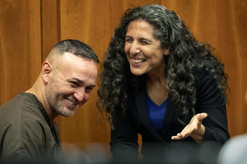 In this Wednesday, May 15, 2019 photo, Lionel Rubalcava talks with Northern California Innocence Project lead attorney Paige Kaneb before his attempted murder conviction was dismissed by a judge in San Jose, Calif. Rubalcava, a Northern California man wrongfully convicted in a 2002 drive-by shooting that left a man paralyzed, was exonerated and freed after 17 years in prison. (Karl Mondon/San Jose Mercury News via AP)